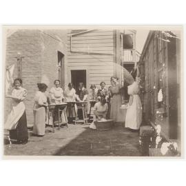 Laundry class being conducted at yard behind Studholme