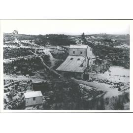 A closer view of the battery shed showing the mine poppet head in the background