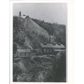 View of winding engine shed, rope & poppet head above mine shaft