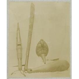 Carved clubs, flute and feeding tube