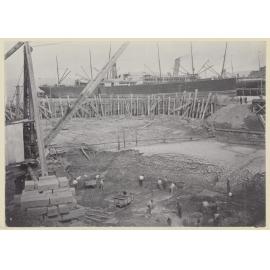 Elevated view of men excavating seabed soil
