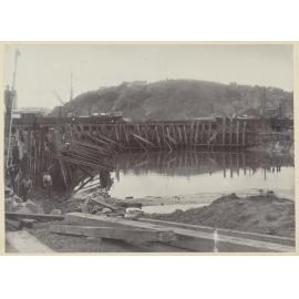 Group of men digging and placing beams