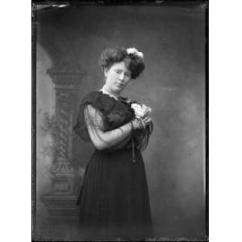 Young woman holding three roses