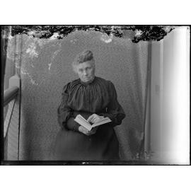 Elderly woman holding a book