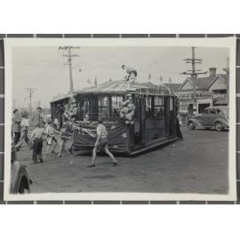 Combination Dummy no.101: Swinging car round on turntable while crew member puts finishing touches to decorations