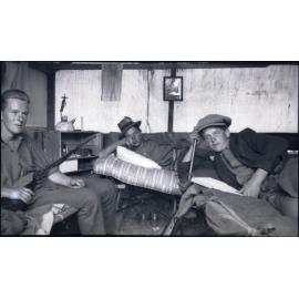 Three men inside a cabin, Beaumont