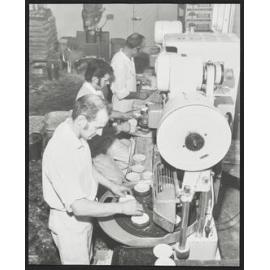 Three men at machines in Laurenson's Bakery, making pies