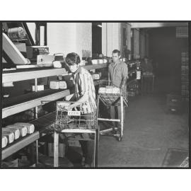 Staff removing loaves from conveyor in Laurenson's Bakery