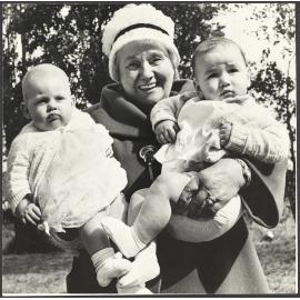 Mabel Howard holding two babies at a Labour Day picnic