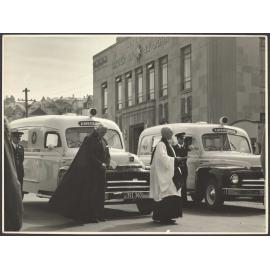 Ceremony on York Place, Dunedin, with two ambulances