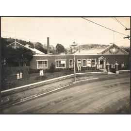 A quiet chat in factory grounds during afternoon tea recess