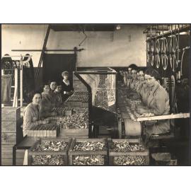 A close up of the 'Vestette' Packing and Wrapping Benches adjoining Match Machine