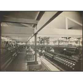 Interior view of large room with spinning machines or 'mules'