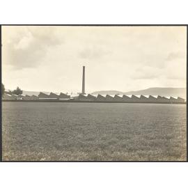 Factory buildings with field of grain in foreground