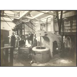 Workers with machine, possibly an industrial spin dryer