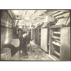 Male workers with cloth and machinery