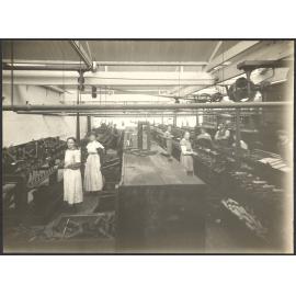 Workers, possibly winding yarn from spinning cones to weaving pirns or bobbins
