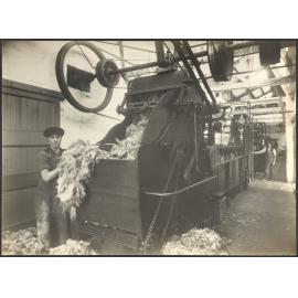 Two workers with wool scouring machine (?)