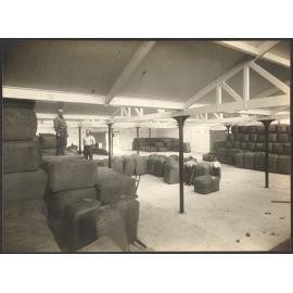 Bales of wool with workers