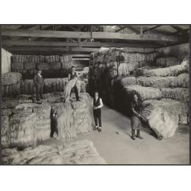 Manager and workers with bales of fibre in Donaghy's factory warehouse