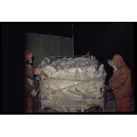 A trailer load of ice arrives at station in winter