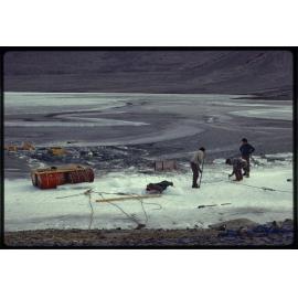 Tractor and trailer resting on bed of lake