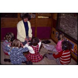 Teacher and children wearing headphones