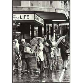 Pedestrians in wet weather crossing Rattray Street