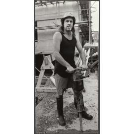 John Clarke as Fred Dagg