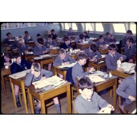 Boys seated at desks in classroom