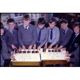 Boys posed with blocks and mathematical equations