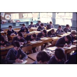 Boys seated at desks in classroom