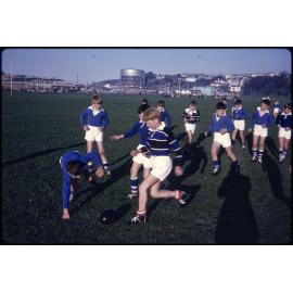 Boys playing rugby at the Oval