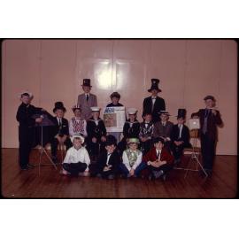Boys in costume with 'Milk adds health' poster