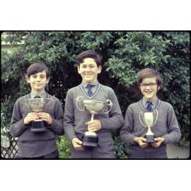 Three boys with prize cups
