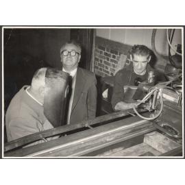 Walter Nash, Thomas Marlowe, and Don Lumb with cutting machine at J. & W. Faulkner factory