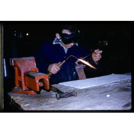 Worker using welding torch