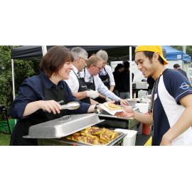 Harlene Hayne serving student at College BBQ