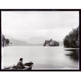Person in a boat on a large body of water, small island in distance, Westland