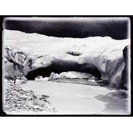Three people standing next to a glacial stream, Westland