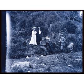 Group of five people next to a steep bank