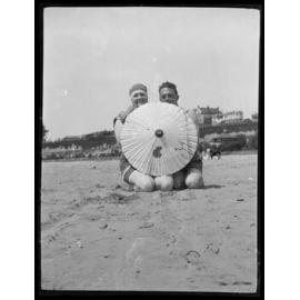 Couple behind parasol, Caroline Bay