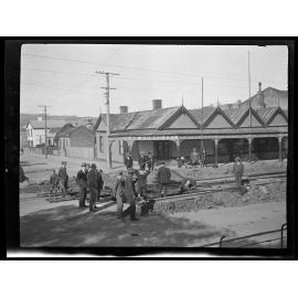 Laying tram lines outside On Chong & Co. Fruiterer, George St