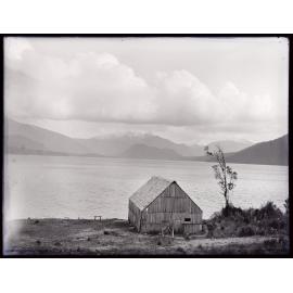 Wooden shed at the edge of a large body of water
