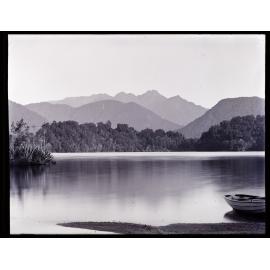 Large unidentified body of water with dinghy at right 