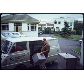Man with cases and Rehabilitation League van