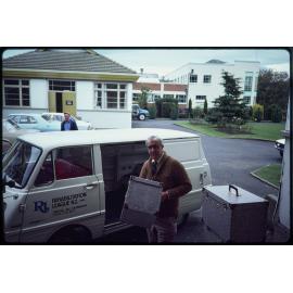 Man with cases and Rehabilitation League van