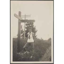 Unidentified woman under a street sign