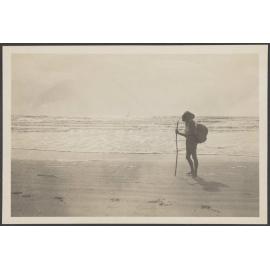 Unidentified woman standing on a beach