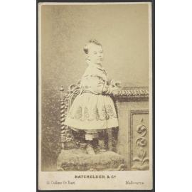 Young child standing on chair